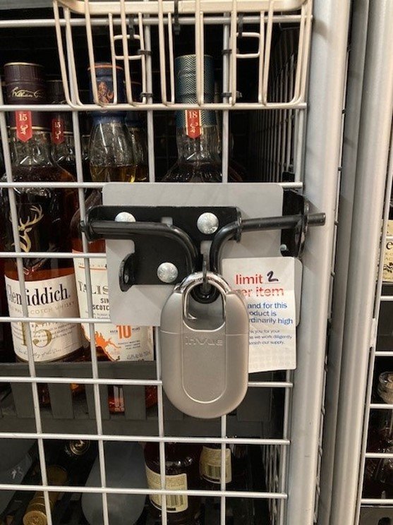 Padlock Protegendo garrafas de bebidas em uma gaiola em uma loja Meijer