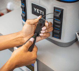 OneKEY destravando uma âncora com trava de cabo presa a um cooler Yeti